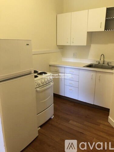 A kitchen with a white fridge and stove.