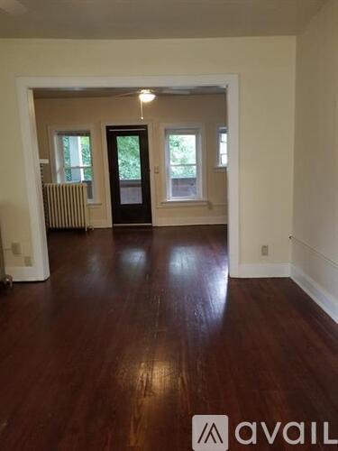 A room with wooden floors and white walls.