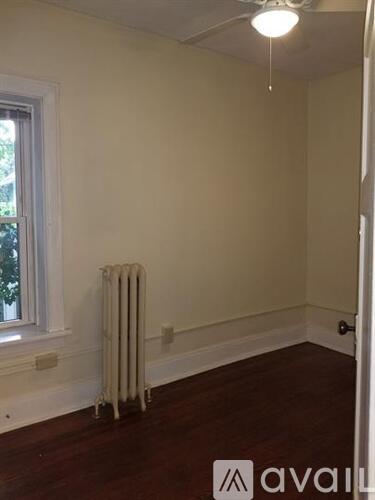 A room with a radiator and a window.