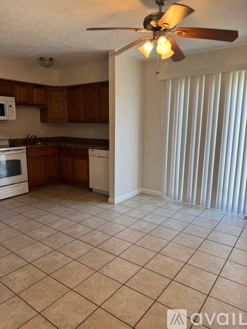 A kitchen with a white oven and brown cabinets.