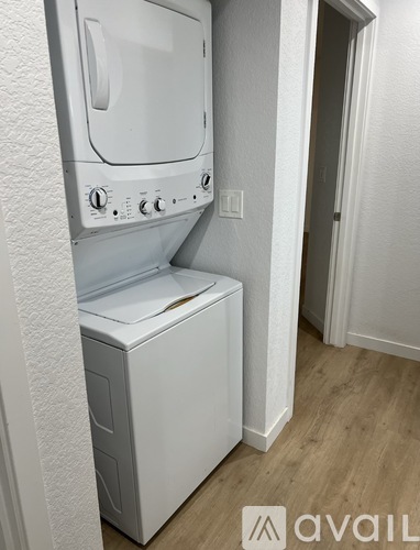 A white washing machine and dryer in a small room.