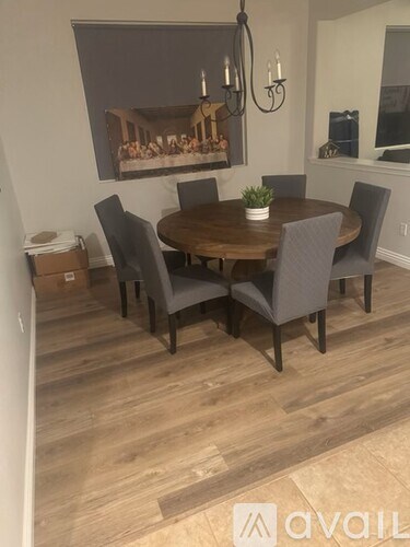 A dining room with a wooden table and chairs.