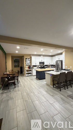 A modern kitchen with a dining table and chairs.