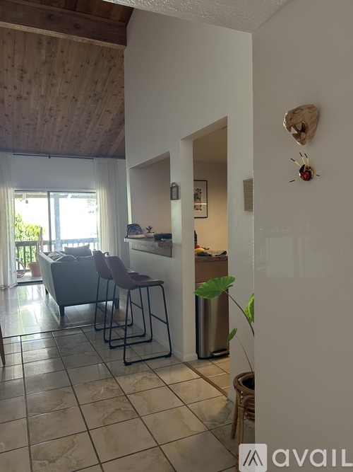 A kitchen area with a table and chairs.