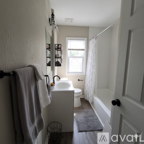 A bathroom with a towel hanging on the towel rack.