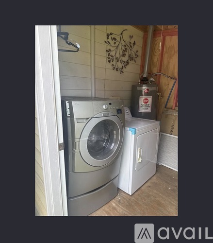 A washing machine is placed next to a dryer in a small room.