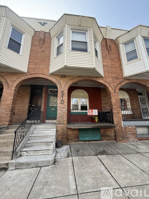 A building with a red door and a sign that says "For Rent".