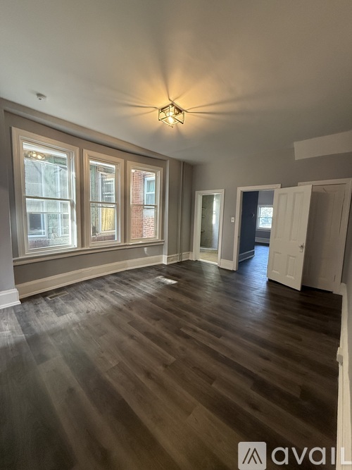 A room with wooden floors and a ceiling fan.