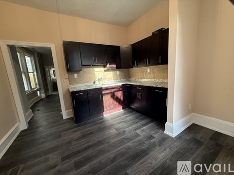 A kitchen with black cabinets and a countertop.
