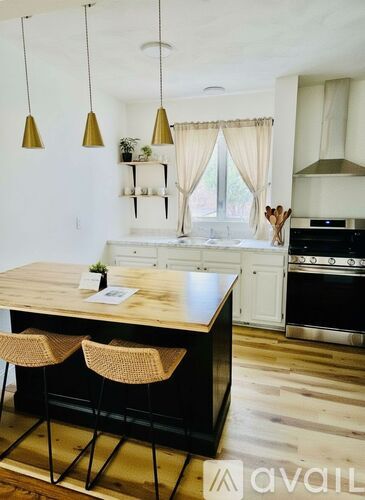 A kitchen with a wooden table and chairs.