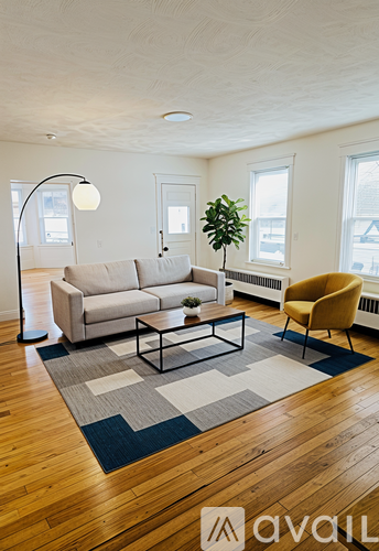 A living room with a couch, chair, and a floor lamp.