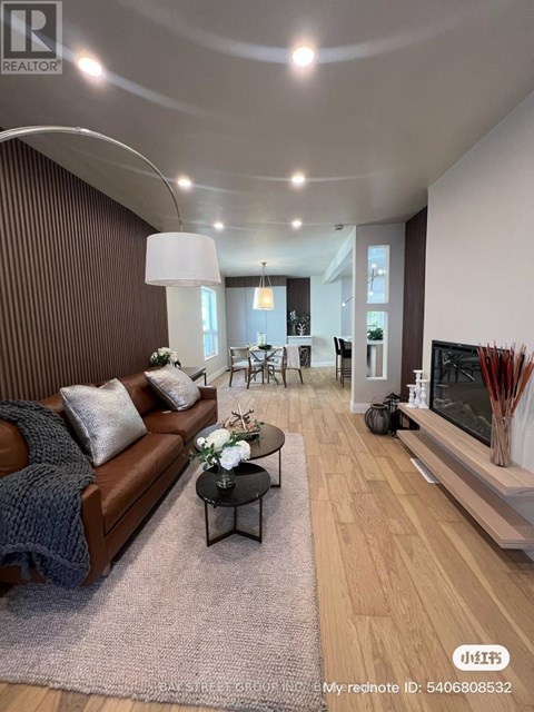 A living room with a brown couch and a coffee table.