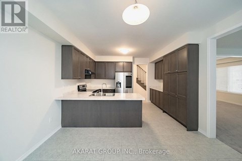 A modern kitchen with dark brown cabinets and a central island.