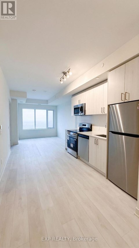 A kitchen with white cabinets and stainless steel appliances.