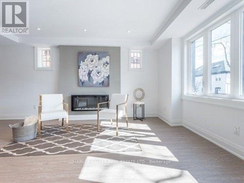 A living room with a fireplace and a painting on the wall.