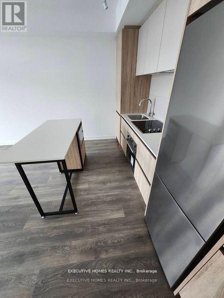 A modern kitchen with a table and chairs.