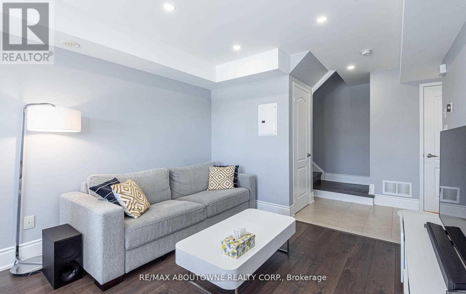 A living room with a grey couch and a white coffee table.