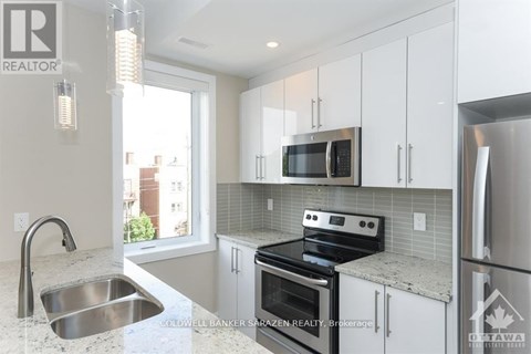 A modern kitchen with a stainless steel oven and microwave.