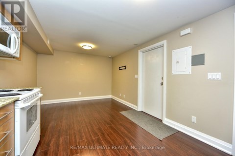 A kitchen with a stove top oven and a doorway leading to another room.