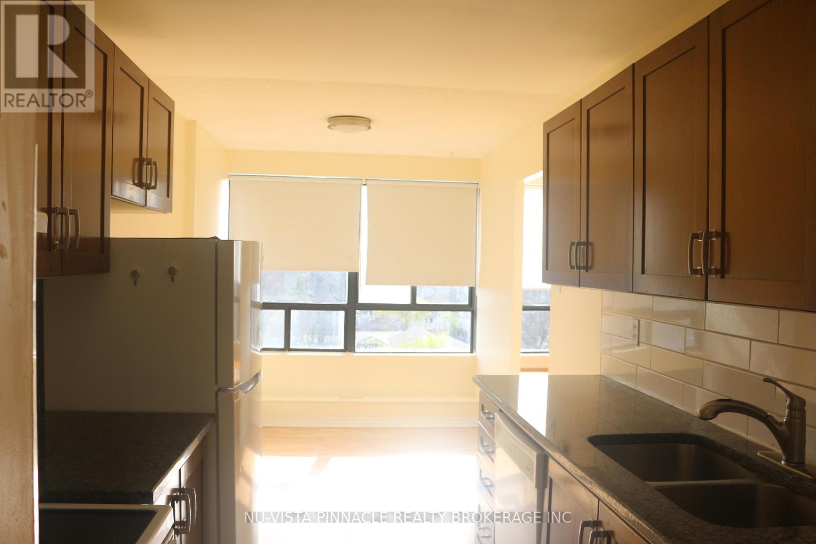 A kitchen with a table and chairs in the middle of it.