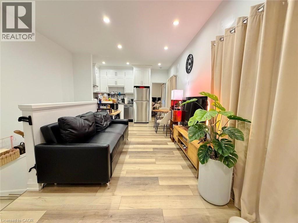 A room with wooden flooring and white walls.