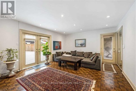 A living room with a rug and a couch.