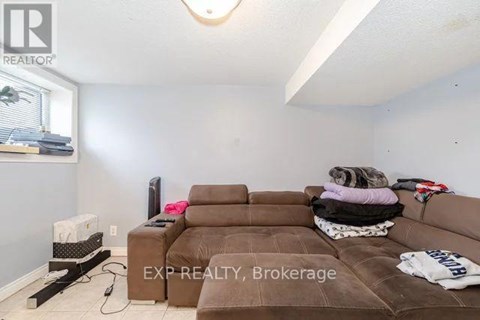 A living room with a brown couch and a flat screen TV.