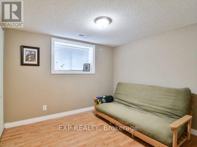 A living room with a couch, chairs, and a rug.