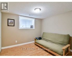 A living room with a couch, chairs, and a rug.