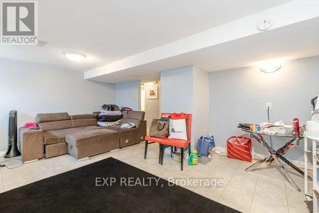 A living room with a couch, chair, and a rug.