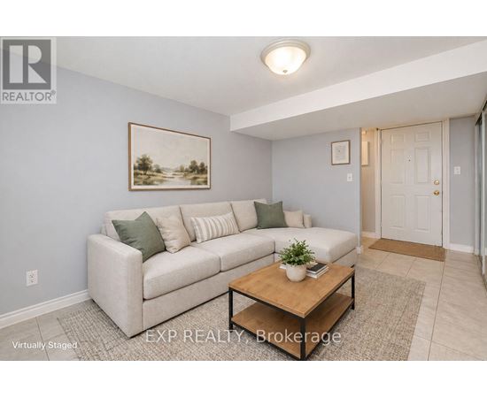 A living room with a couch, chair, and a rug.