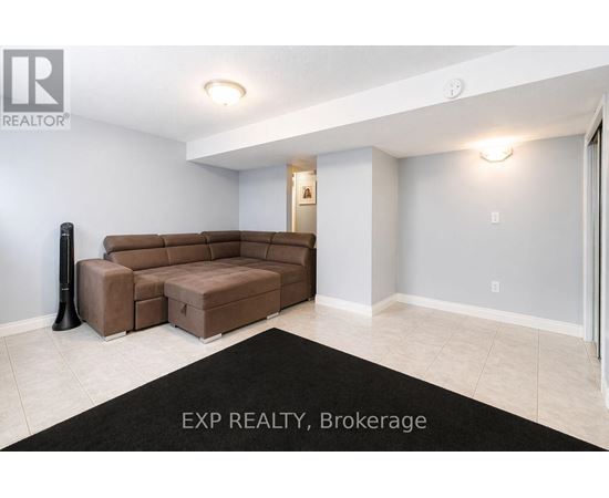 A kitchen with white cabinets and appliances, a rug on the floor, and a box of TJ Maxx on the counter.