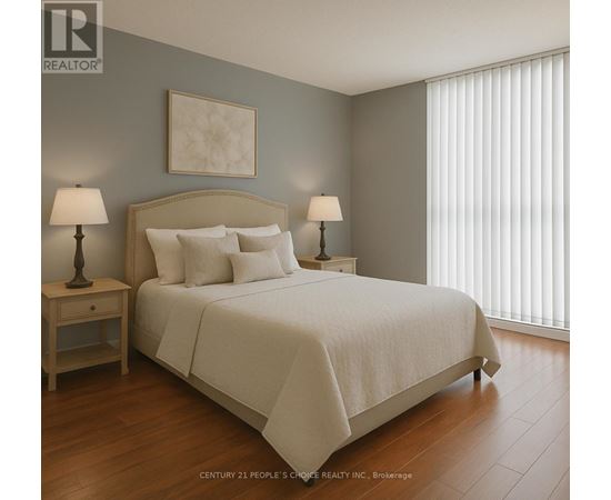 A bedroom with a large bed and two lamps.