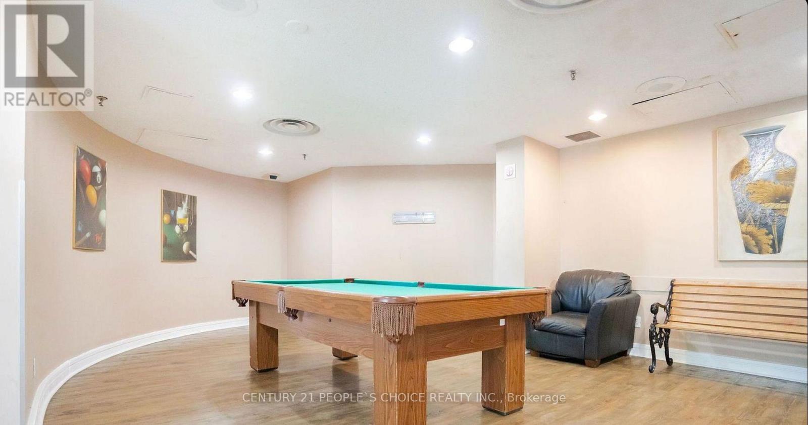 A pool table in a room with a chair and a vase.