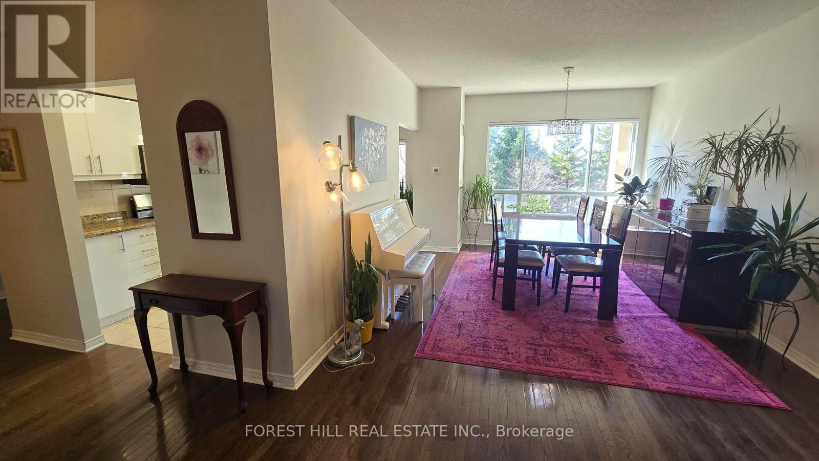 A living room with a dining table and chairs.