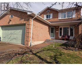 A brick house with a garage door and a sign that says "HOMELIFE KINGSVIEW REAL ESTATE INC Brokerage".