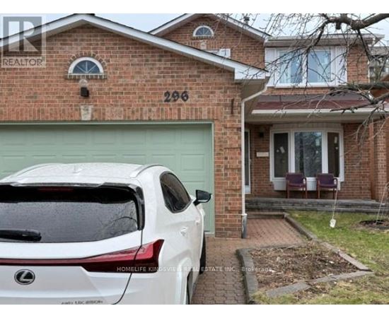 A white Lexus SUV is parked in front of a brick house with the number 296 on it.