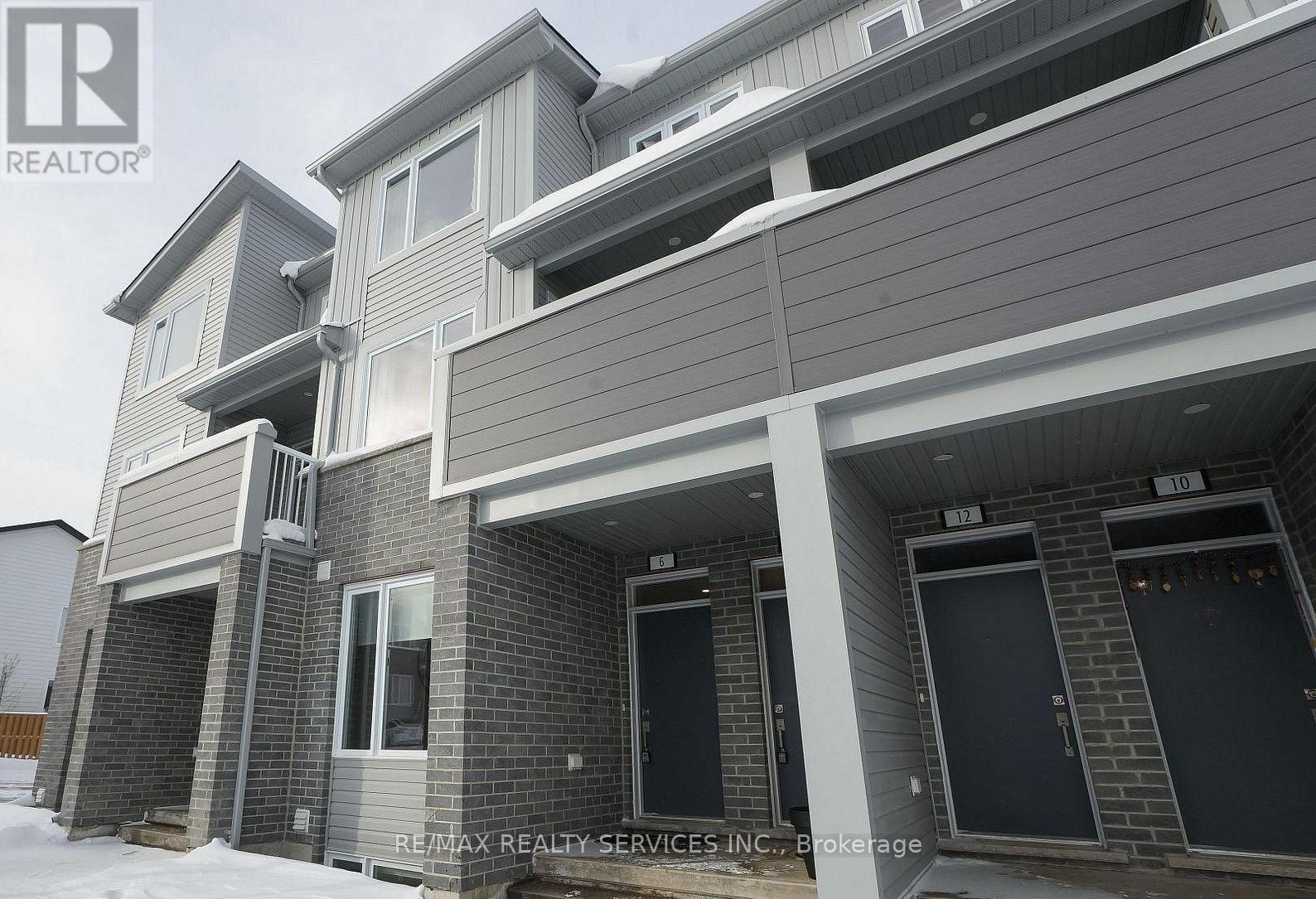 A modern house with a grey and white exterior is shown.