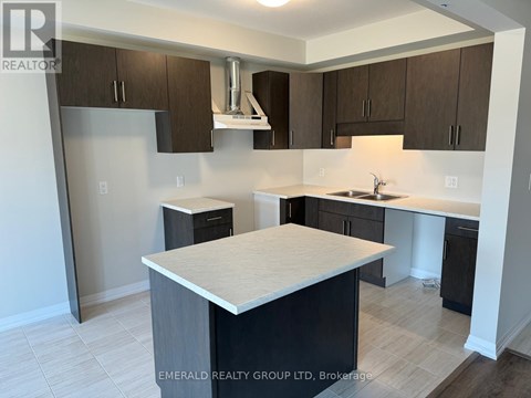 A kitchen with a white counter top and brown cabinets.
