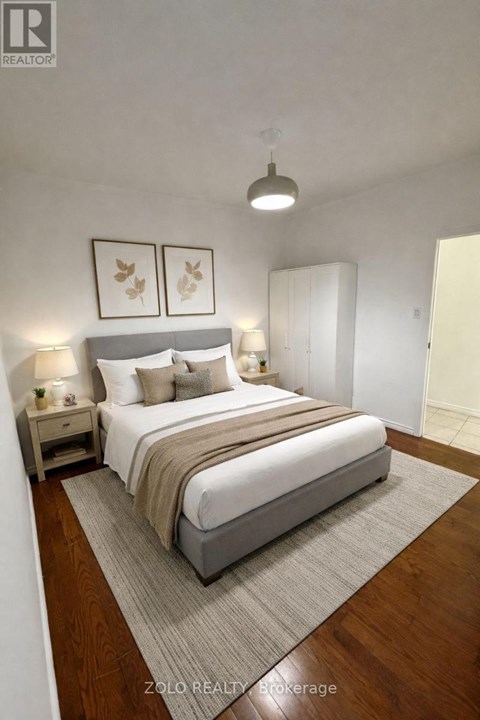 A bedroom with a large bed and two nightstands.