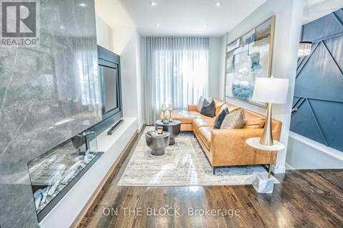 A living room with a brown couch and a television.