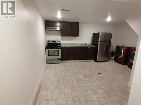 A kitchen area with a washing machine and dryer.