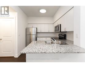 A kitchen with granite countertops and stainless steel appliances.