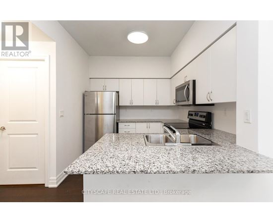 A kitchen with granite countertops and stainless steel appliances.