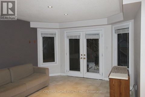 A living room with a couch and a large window.