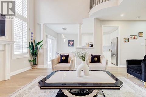 A living room with a glass coffee table and a couch with two cushions.