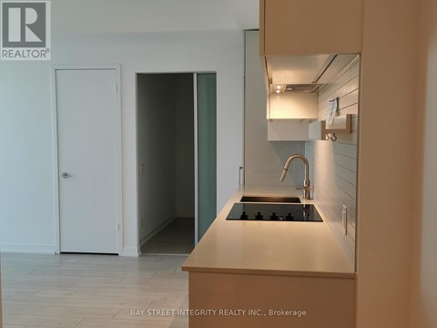 A kitchen with a stove top oven and a sink.