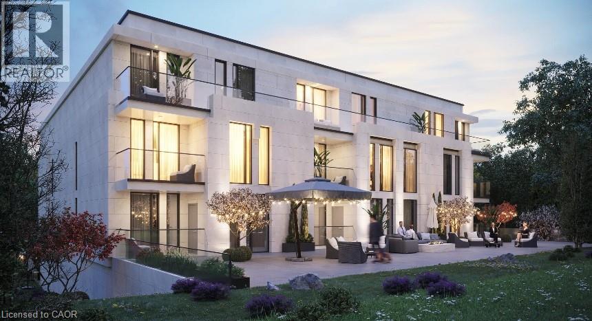 A modern house with a white exterior and a garden in front.