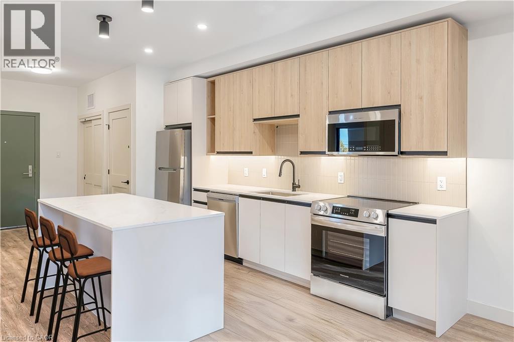 A modern kitchen with wooden cabinets and stainless steel appliances.