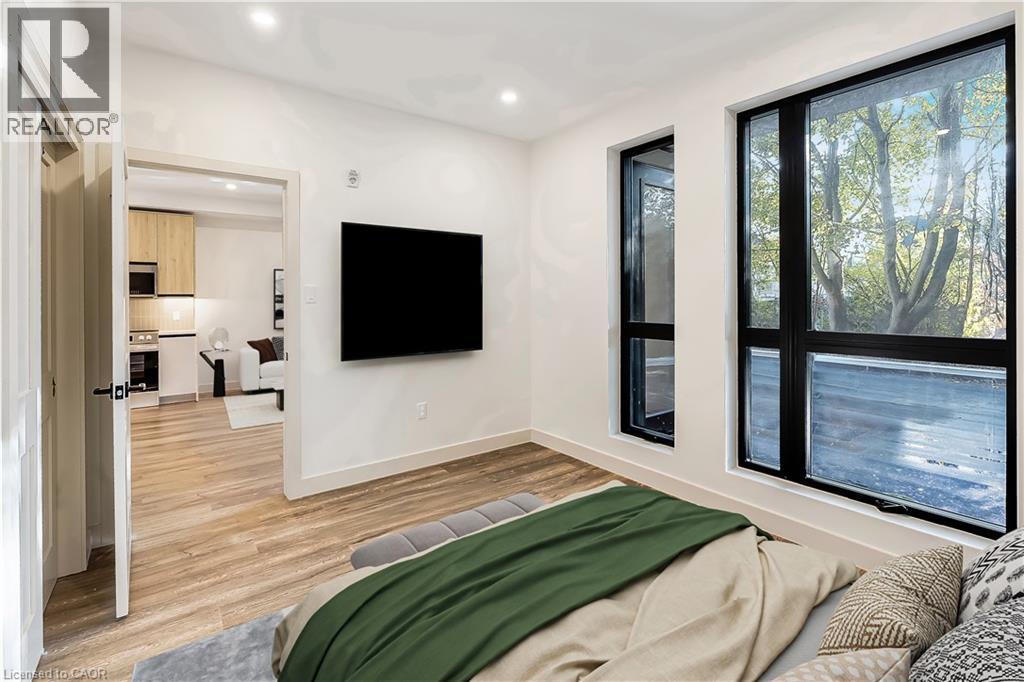 A modern living room with a flat screen TV mounted on the wall.